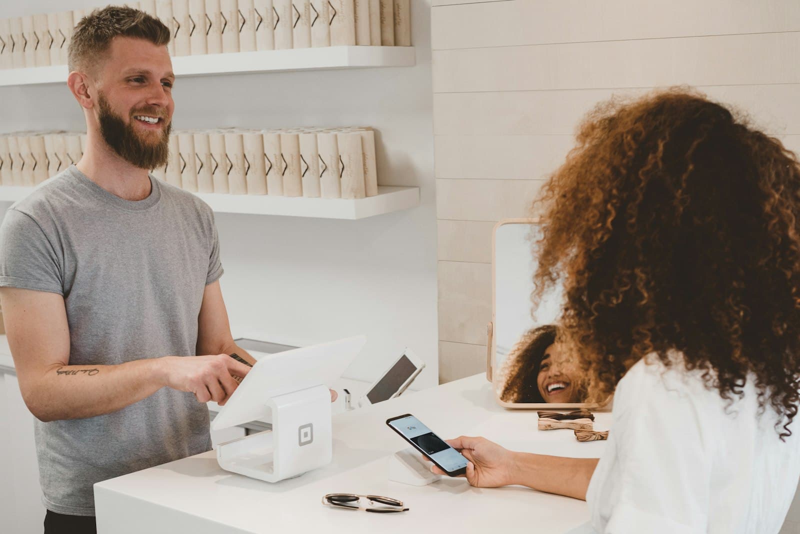 A customer paying at a shop counter